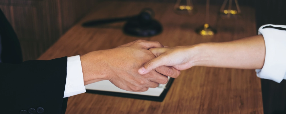 An Albuquerque Humanitarian Relief Lawyer shaking hands with a client.