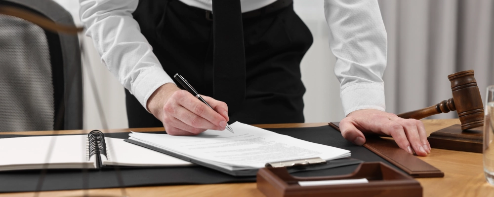 An Albuquerque Immediate Relative Visa Lawyer standing while taking down notes.