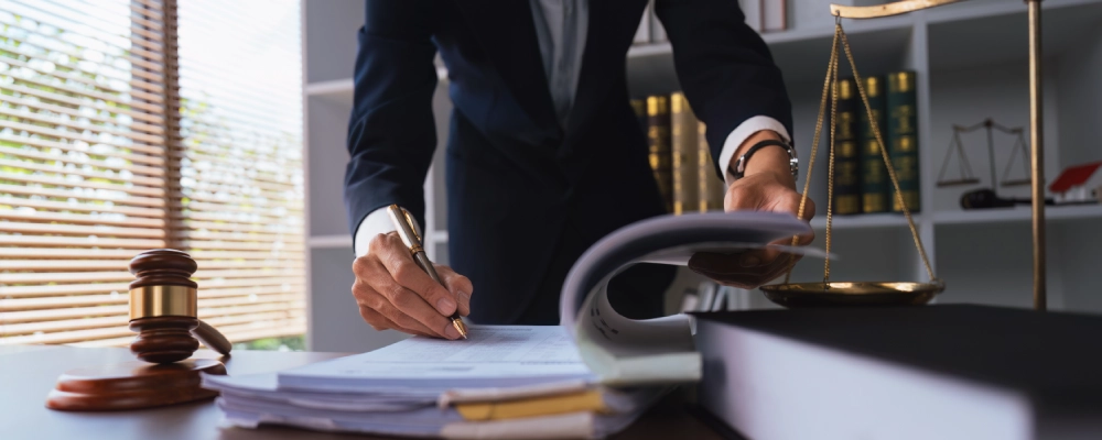 An Albuquerque Immigration Appeals Lawyer signing a document.