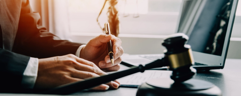 An Albuquerque Provisional Waiver Lawyer writing notes beside the hammer and gravel.