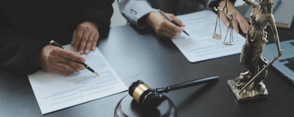 Albuquerque Temporary Protected Status Lawyers writing notes and reviewing the case of the client.