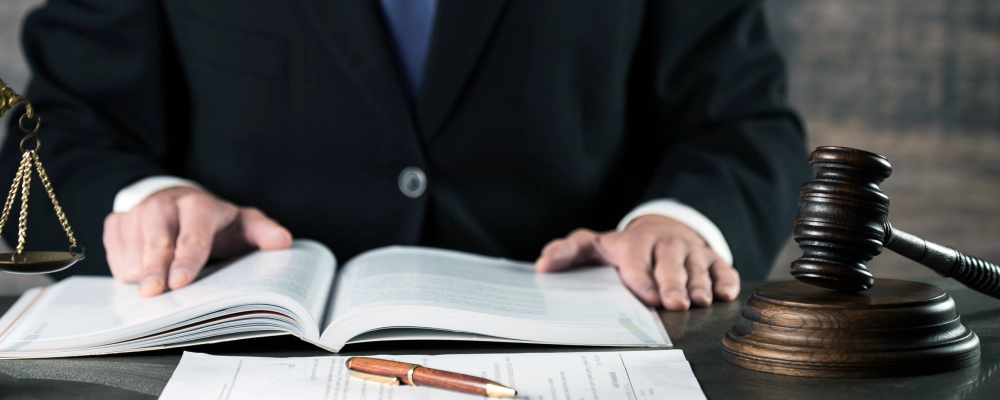 A Dallas deportation lawyer reviewing a law book to help a client with their case.