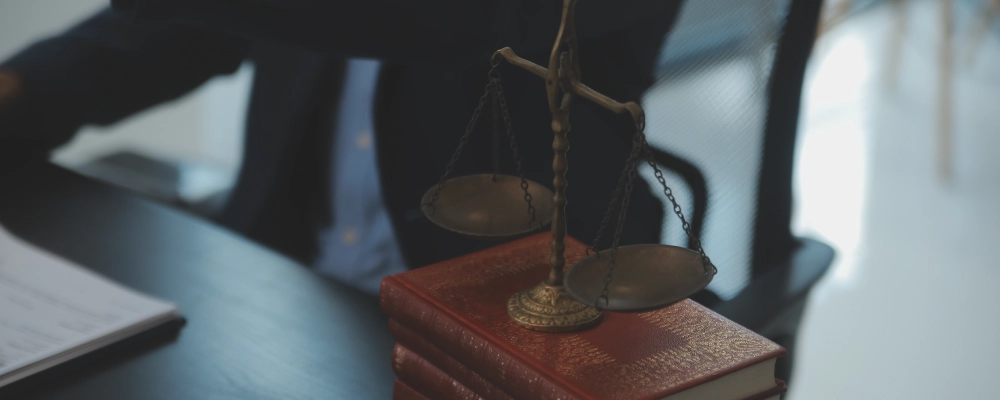 A Dallas employment immigration lawyer standing behind his desk and reviewing files for a client.