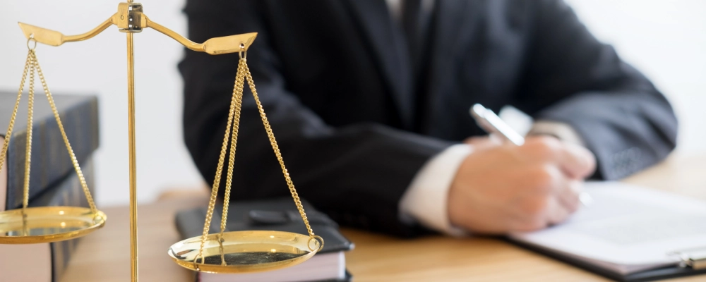 A Dallas immigration lawyer seated at a desk and working on documents for a client.