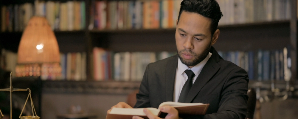 A Dallas Student Visa Lawyer reading a book.