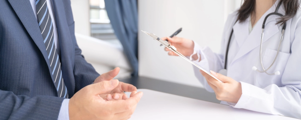 A Dallas T visa lawyer consulting medical professional about the psychological documentation of his client.