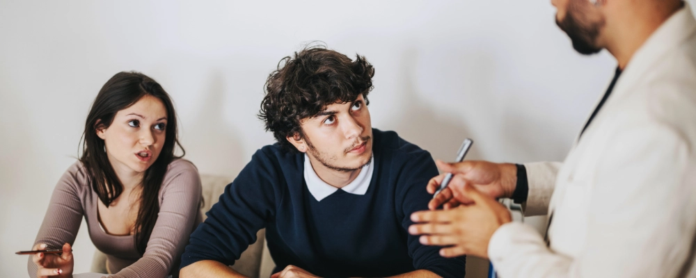 An Irving student couple consults a STEM OPT immigration lawyer on navigating the student visa extension process.