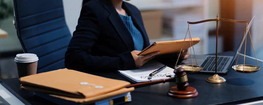 An Allen immigration lawyer sits while looking down at an envelope held in both hands