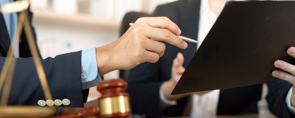 A McKinney immigration lawyer discussing case details with a colleague